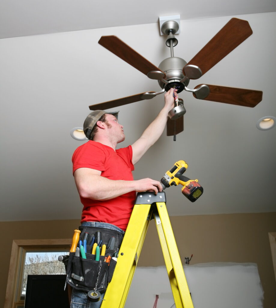 elctrician installing ceiling fan after quoting the installation of ceiling fan cost